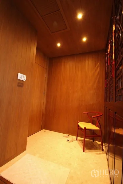Condominium for rent or sale in Khlong Toei, Bangkok - Private foyer with wooden walls, recessed lights, and a security keypad.