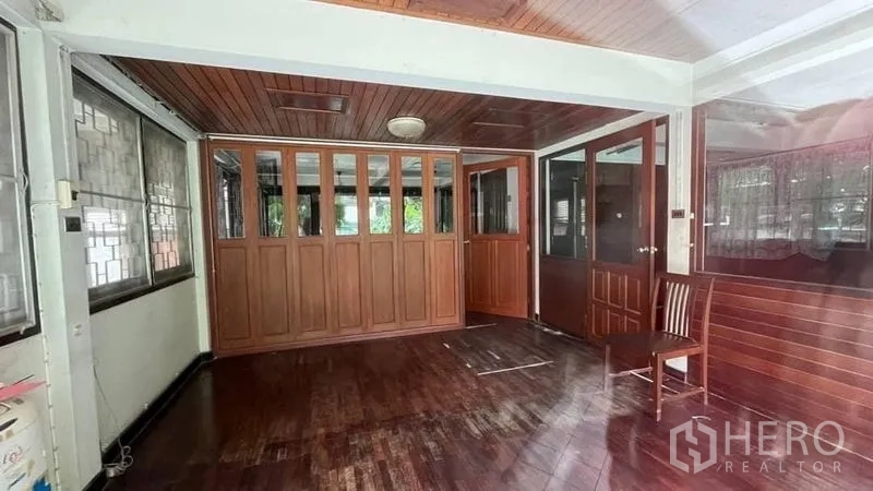 บ้าน ให้เช่า - ห้องนั่งเล่น ผนังและฝ้าไม้ พร้อมประตูกระจกและหน้าต่าง