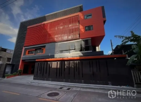 Shophouse for rent or sale in Khlong Toei, Bangkok - Modern red-and-black multi-storey shophouse exterior on a street in Ekkamai.