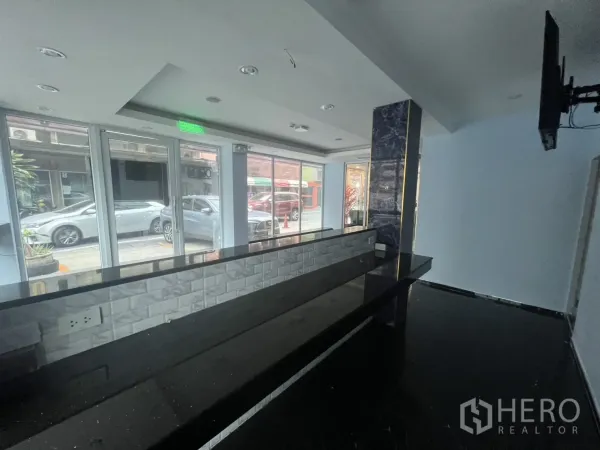 Retail Space for rent in Khlong Toei, Bangkok - Street-facing retail interior with glass frontage, long service counter and recessed lighting in Khlong Toei.