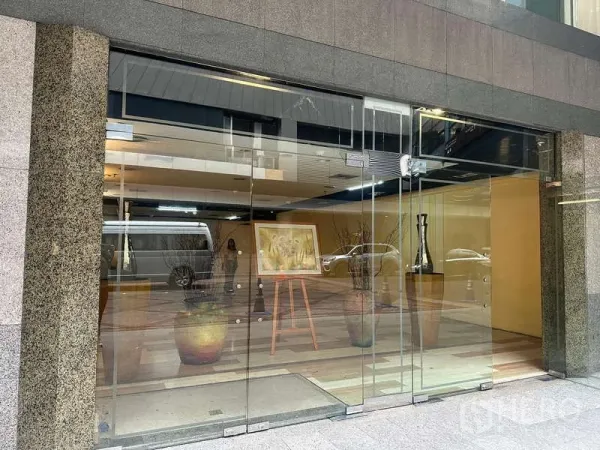 Retail Space for rent - Street-level glass frontage with sliding doors and interior display area inside the arcade.
