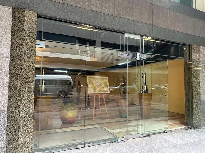 Retail Space for rent - Street-level glass frontage with sliding doors and interior display area inside the arcade.