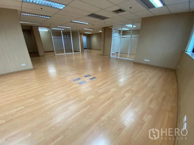 สำนักงาน ให้เช่าในWatthana, Bangkok - โซนทำงานแบบโอเพ่นสเปซ พื้นลามิเนต ไฟฟลูออเรสเซนต์ และผนังกระจกกั้นห้องประชุม