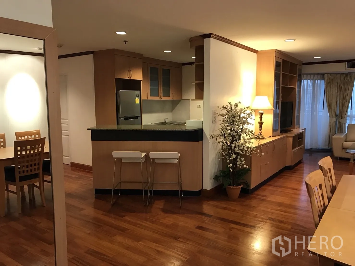 Condominium for rent in Khlong Toei, Bangkok - View from dining to breakfast bar and kitchen with cabinets and refrigerator.