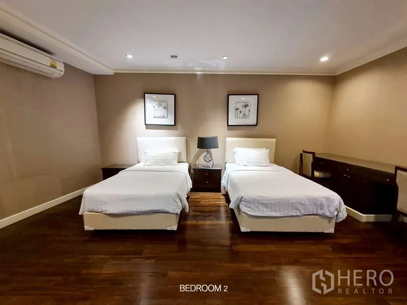 Retail Space for rent in Watthana, Bangkok - Bedroom with twin beds, nightstand, and warm wood flooring