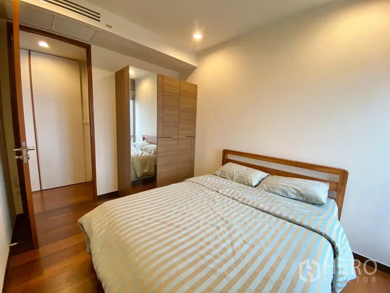 Condominium for rent - Second bedroom with double bed, mirrored wardrobe and neutral décor.