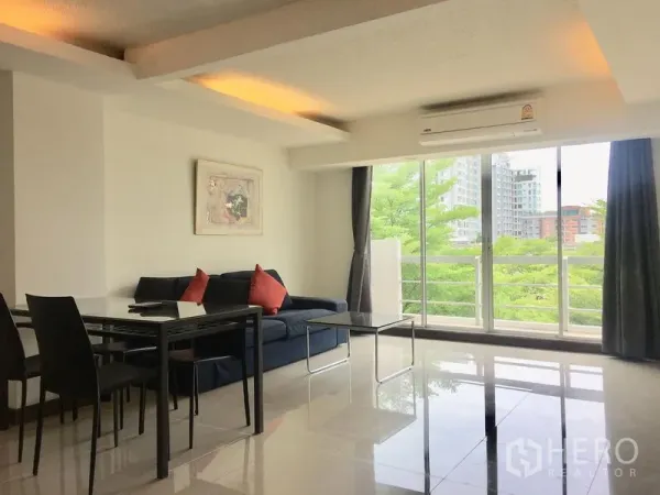Condominium for rent in Khlong Toei, Bangkok - Bright living and dining area at Waterford Sukhumvit 50 with large windows, balcony greenery and city views.