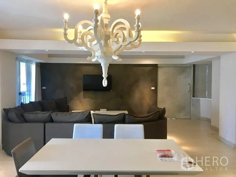 Condominium for rent in Watthana, Bangkok - Bright entry corridor leading to an open-plan dining area with light wood floors and full-length curtains.