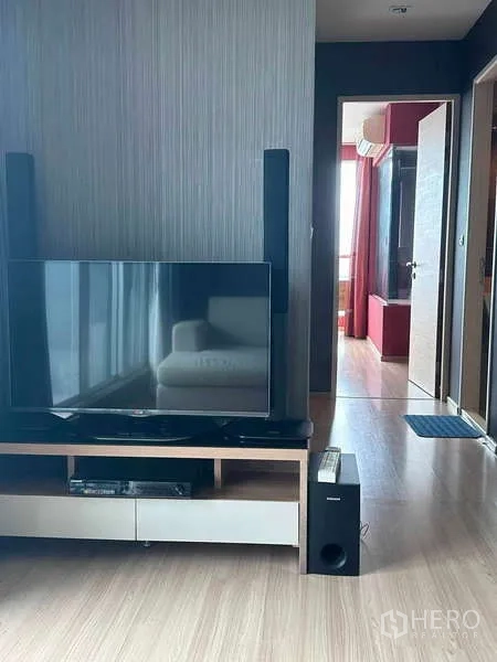 Condominium for sale in Phaya Thai, Bangkok - TV console in the living room with hallway leading to the bedroom.