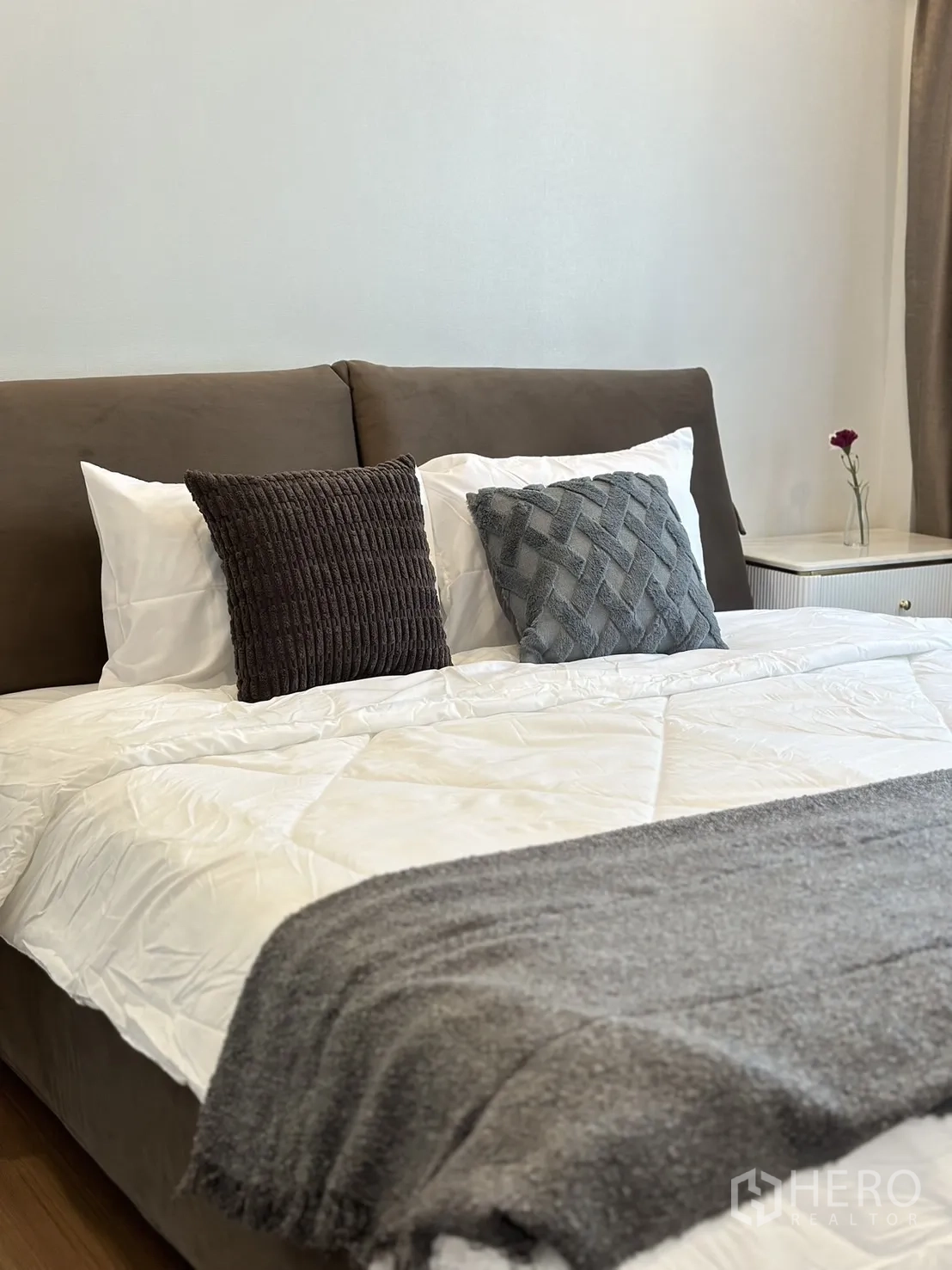 Detached House for rent or sale - Close-up of bed with white duvet and gray throw, bedside table with flower.