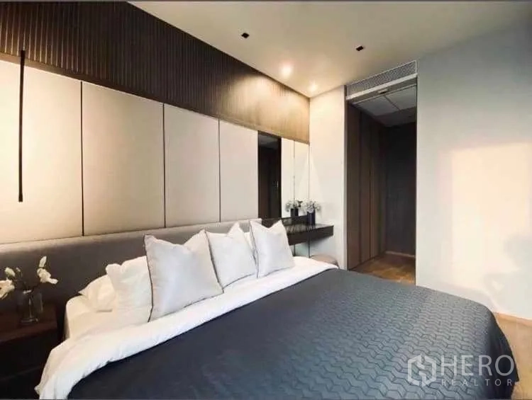 Condominium for rent or sale - Serene bedroom with padded headboard, pendant lighting and dressing desk.