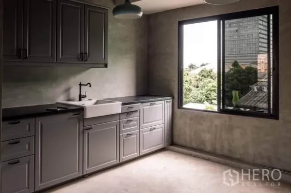 Home Office for rent or sale in Lak Si, Bangkok - Fitted pantry with grey cabinetry, farmhouse sink and a window with neighborhood views.