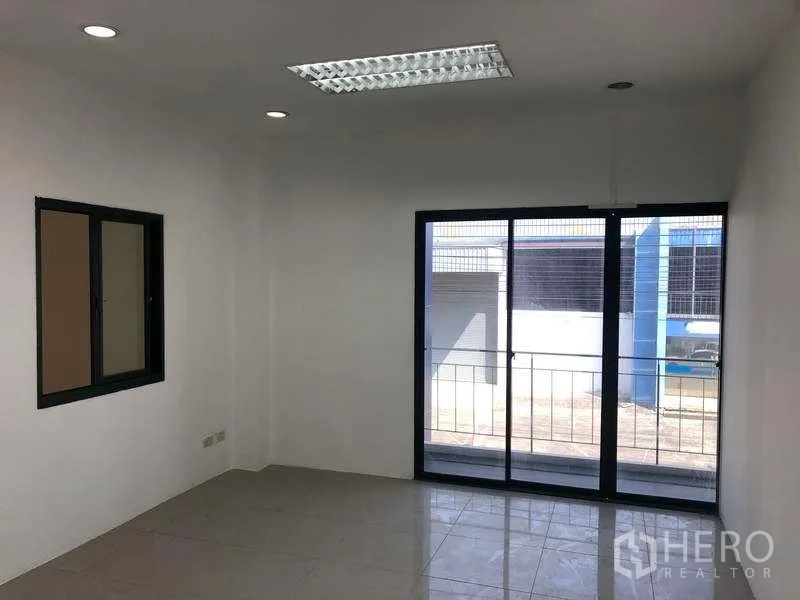Factory for rent or sale in Bang Phli, Samut Prakan - Office with sliding glass balcony door and side window providing natural light.