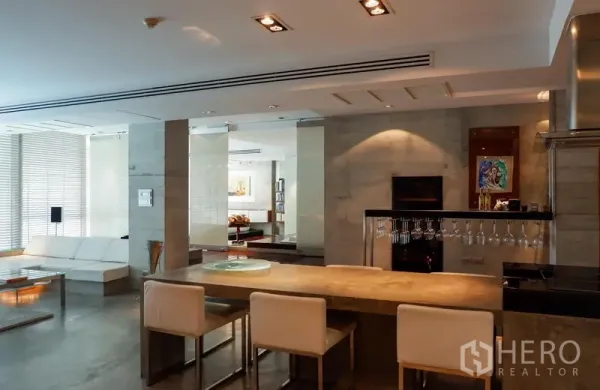 Condominium for rent or sale in Khlong Toei, Bangkok - Spacious dining and lounge area with long breakfast bar, ambient lighting and glass partition.