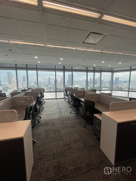 Office Space for rent in Dusit, Bangkok - Open-plan office with bench desks and panoramic Bangkok skyline through floor-to-ceiling windows.