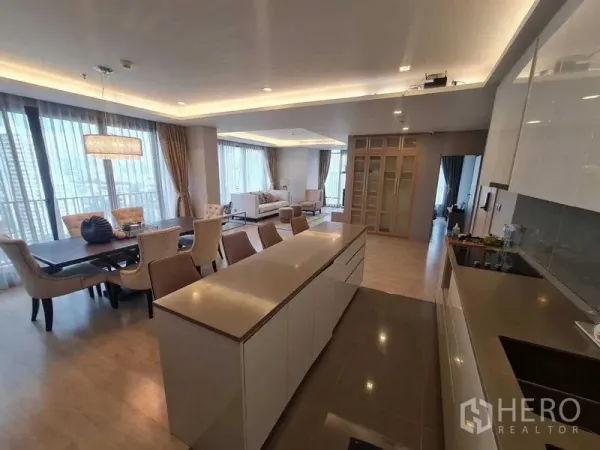 Condominium for sale - Open-plan living, dining and modern kitchen with island, floor-to-ceiling windows and city views in an Ekkamai condo.