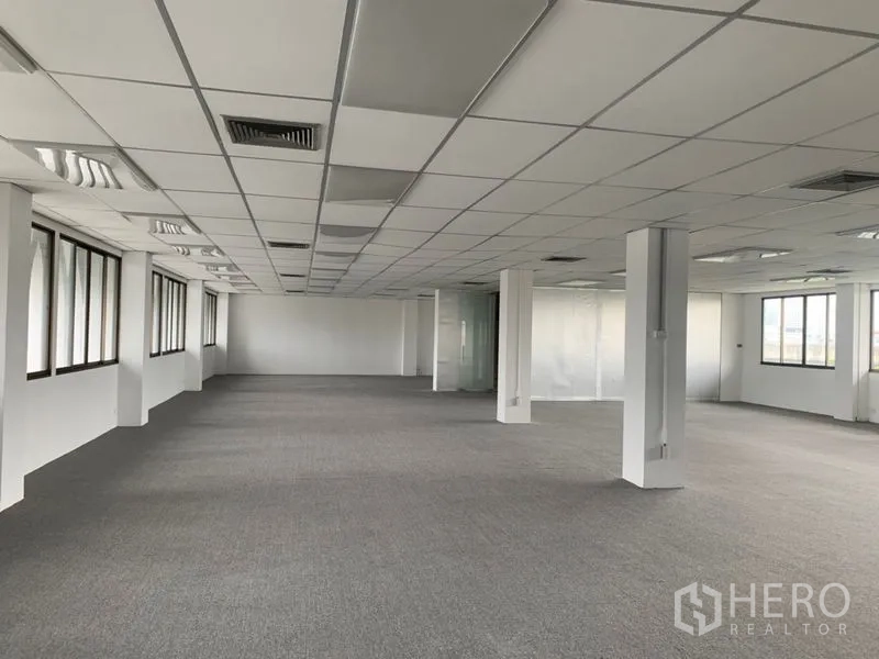 Office Space for rent in Ratchathewi, Bangkok - Open workspace leading to a glass conference room, drop ceiling with air-conditioning vents, and perimeter windows.