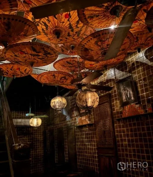Retail Space for rent - Ceiling covered with decorative paper parasols and hanging lanterns above a tiled corridor.