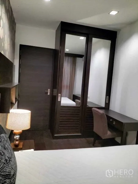 Condominium for rent in Ratchathewi, Bangkok - Bedroom corner with sliding-door closet and small work desk.