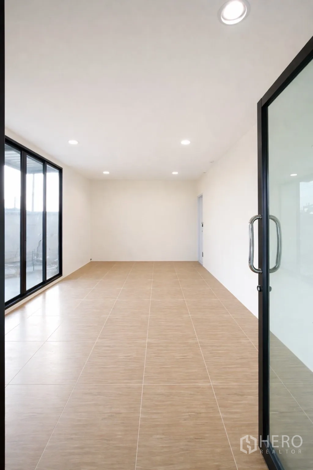Warehouse for rent in Prawet, Bangkok - Office room with tile flooring, recessed lights and a glass entry door.