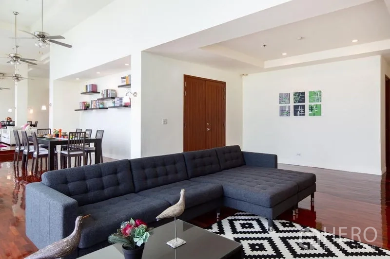 Condominium for rent in Bang Rak, Bangkok - Second living room with a charcoal sectional sofa and contemporary decor.