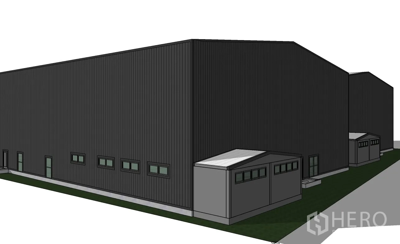Warehouse for rent in Prawet, Bangkok - Long side of the warehouse with rows of windows and a detached outbuilding near the corner.