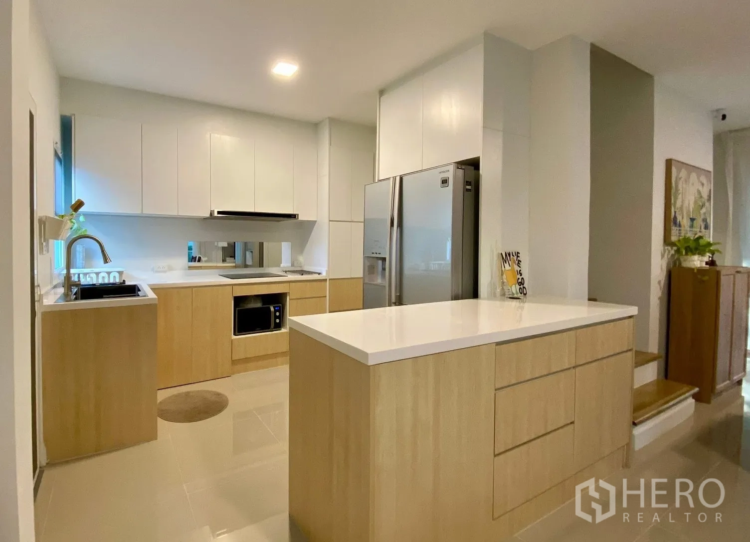 Semi-detached House for rent in Bang Phli, Samut Prakan - Contemporary kitchen with island, white countertops and wood cabinets.