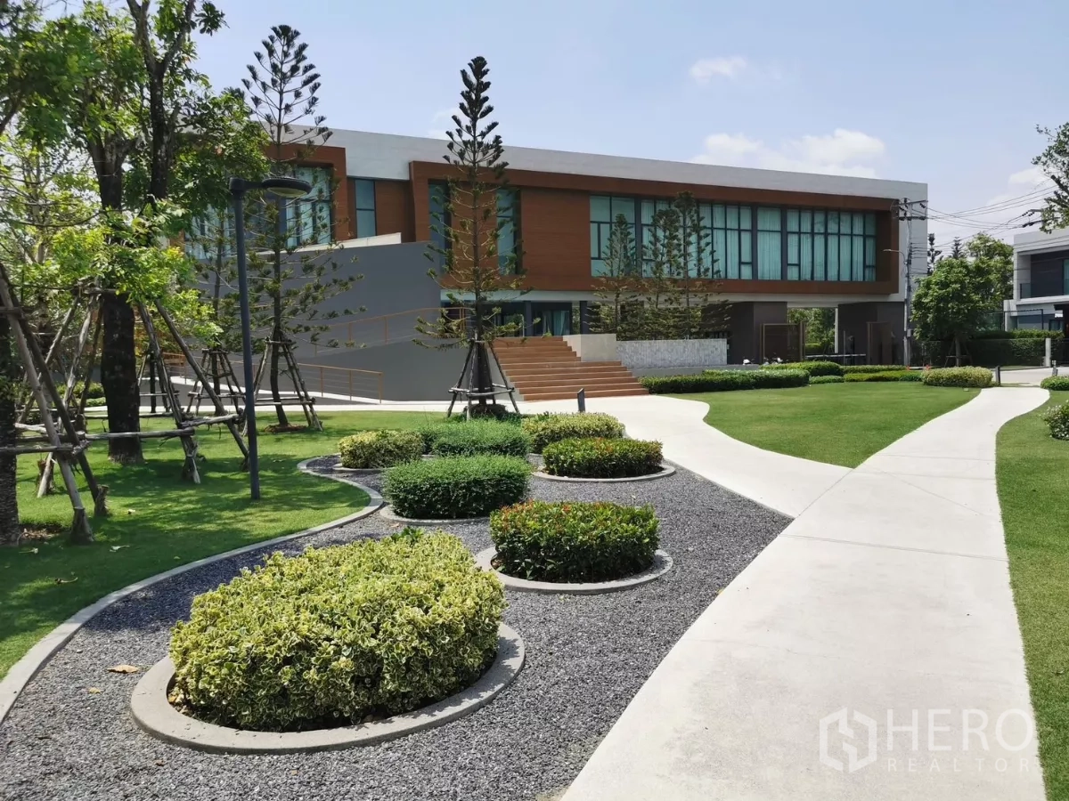 Detached House for rent in Bang Phli, Samut Prakan - Clubhouse building surrounded by landscaped gardens, paths and mature trees.