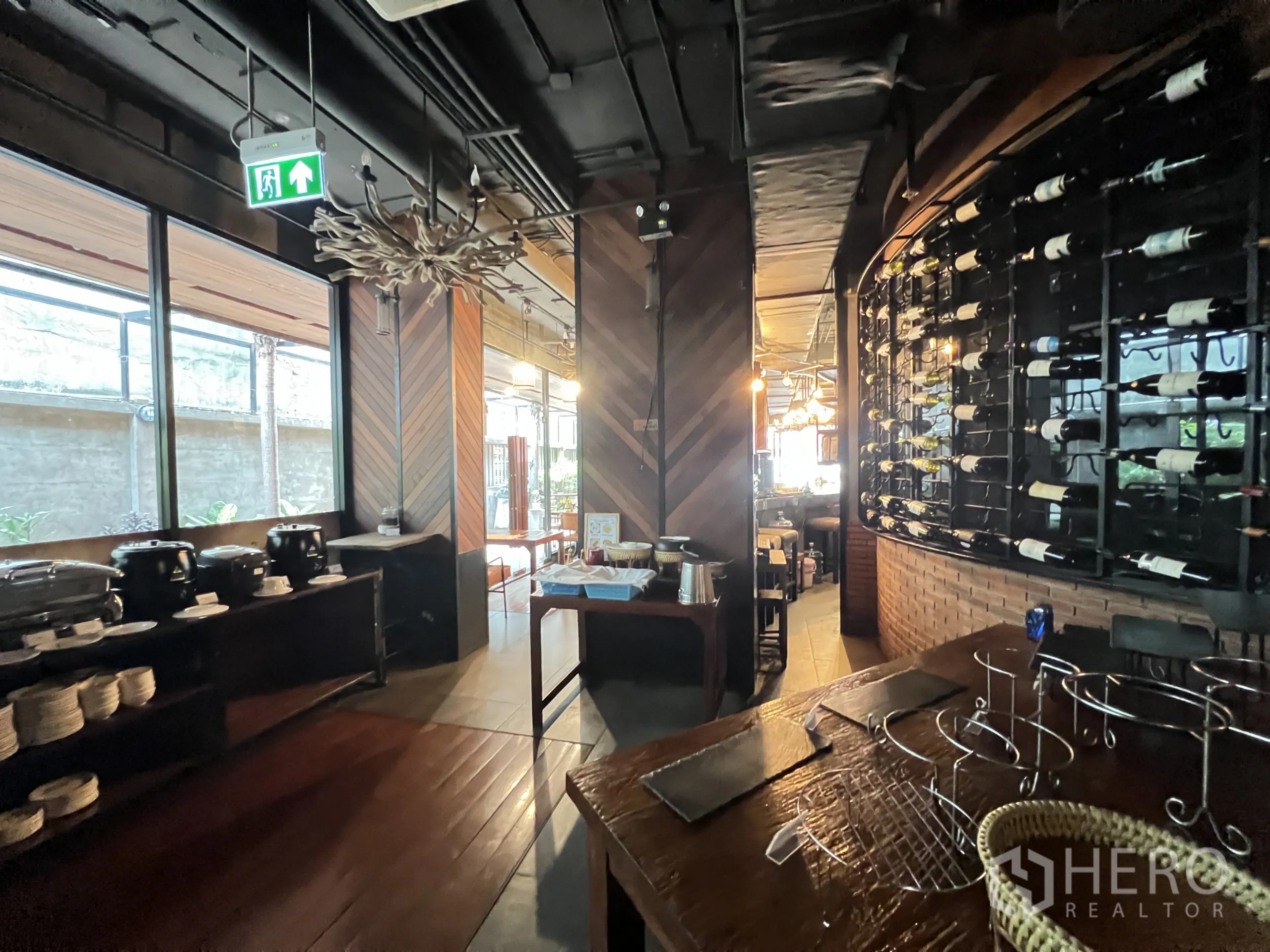 Retail Space for rent in Watthana, Bangkok - Buffet and bar corner with chevron wood walls, wine display rack, and large windows.