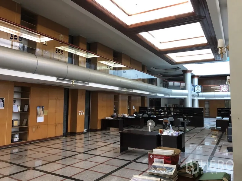Factory for rent in Bang Bua Thong, Nonthaburi - Open‑plan office with built‑in cabinetry, large skylights, and tiled flooring.