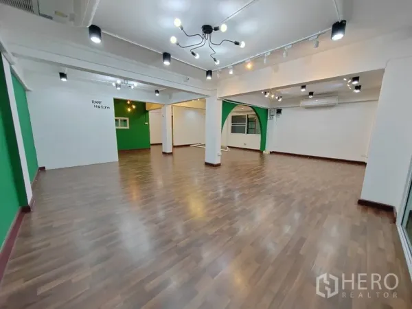 Retail Space for rent in Khlong Toei, Bangkok - Open-plan retail interior with wood flooring, track lighting and green accent walls