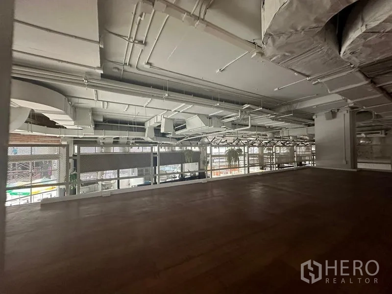 Retail Space for rent in Watthana, Bangkok - Mezzanine level with warm wood floor overlooking a bright retail space.
