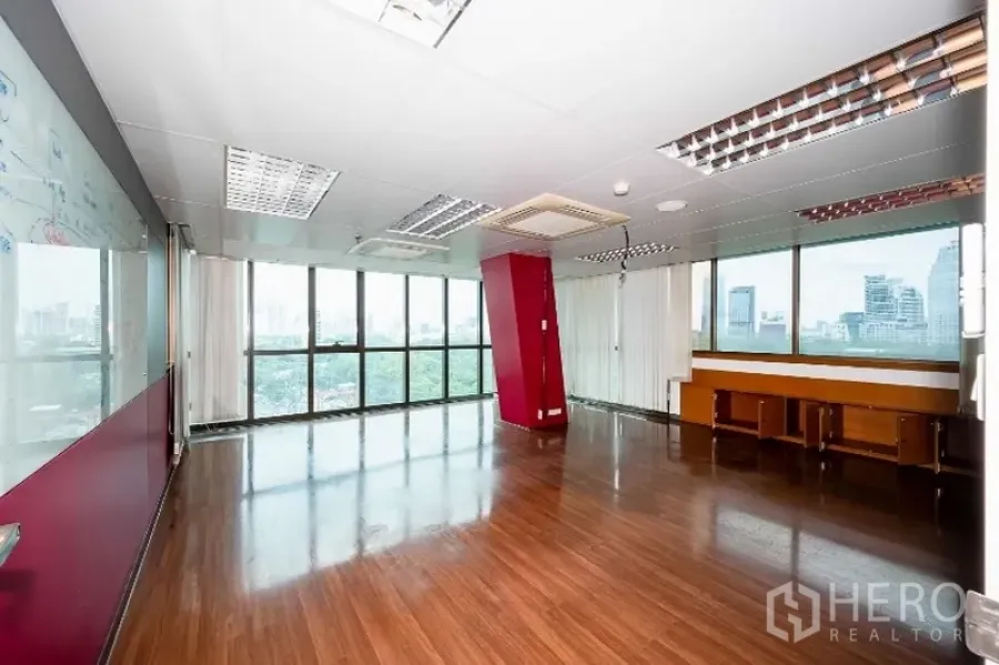 Office Space for rent in Pathum Wan, Bangkok - Large open-plan office with dark wood floors, floor-to-ceiling windows, a glass whiteboard wall, and skyline views.