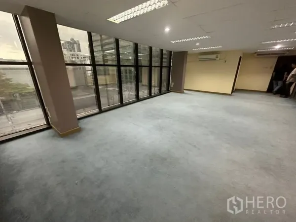 Office Space for rent in Bang Rak, Bangkok - Large office area with expansive windows, split-type air conditioners and city outlook.