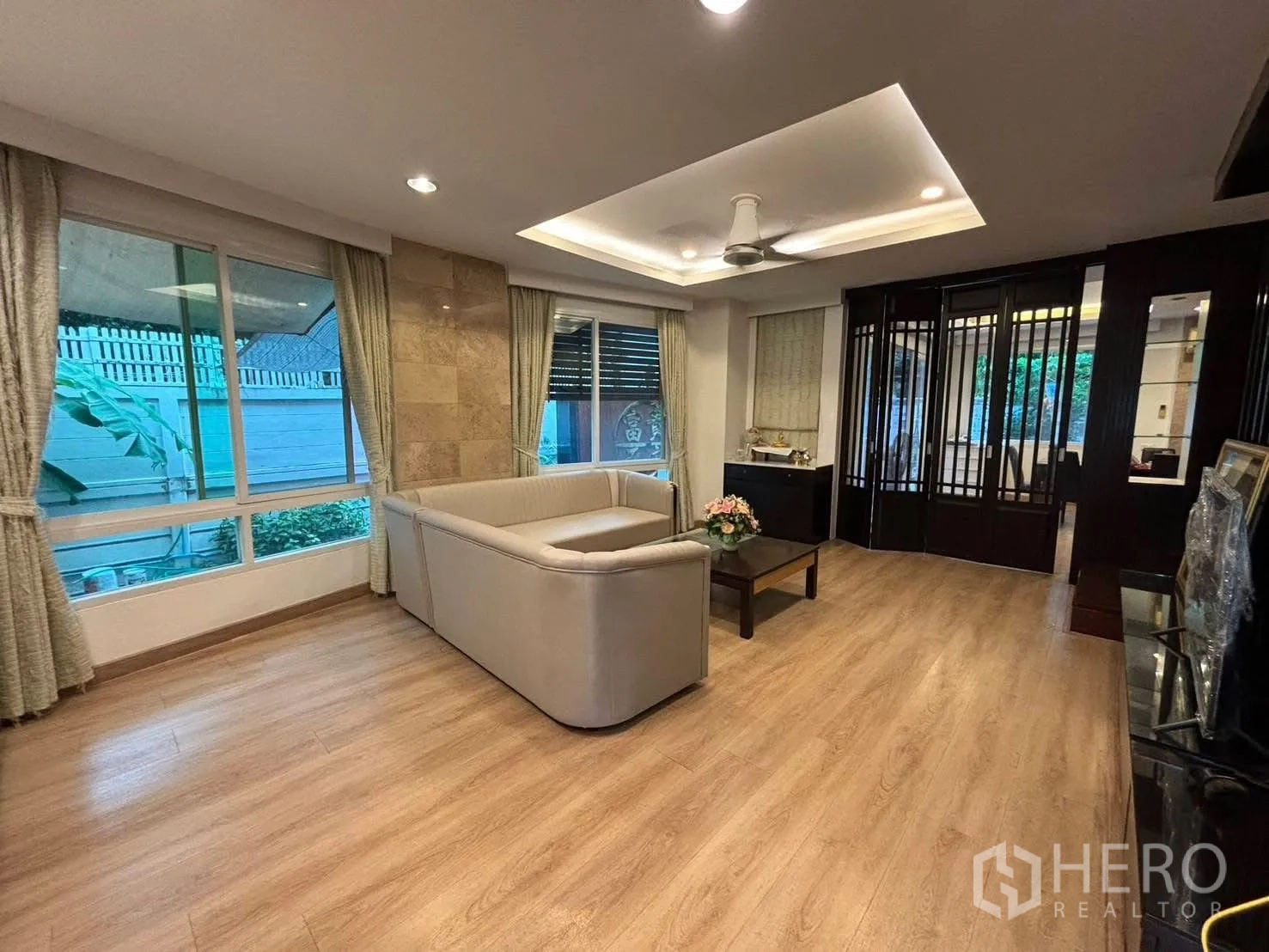 独立式住宅 出租在Bang Kapi, Bangkok - 客厅区带筒灯和深色木质隔断