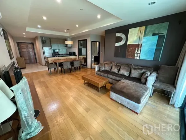 Condominium for rent in Sathon, Bangkok - Sathon condo living room with hardwood floors, L-shaped sofa and dining area