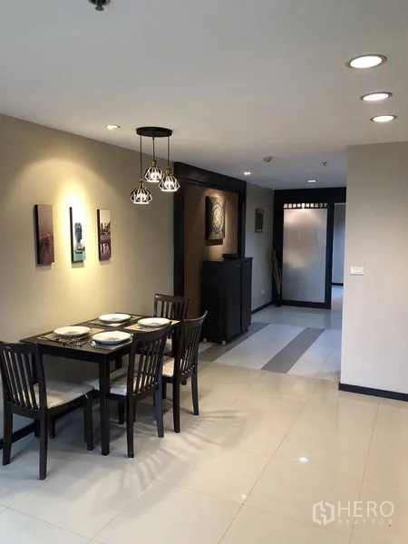 Condominium for rent in Khlong Toei, Bangkok - Dining space for four with pendant lights and neutral walls.
