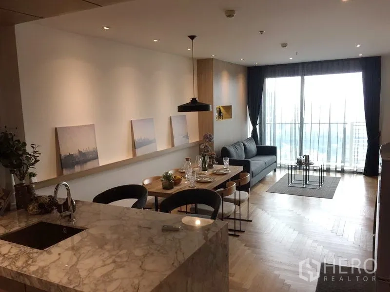 公寓 出售在Watthana, Bangkok - 开放式客餐厅，云石中岛厨房、现代灯具、沙发与可观景阳台。