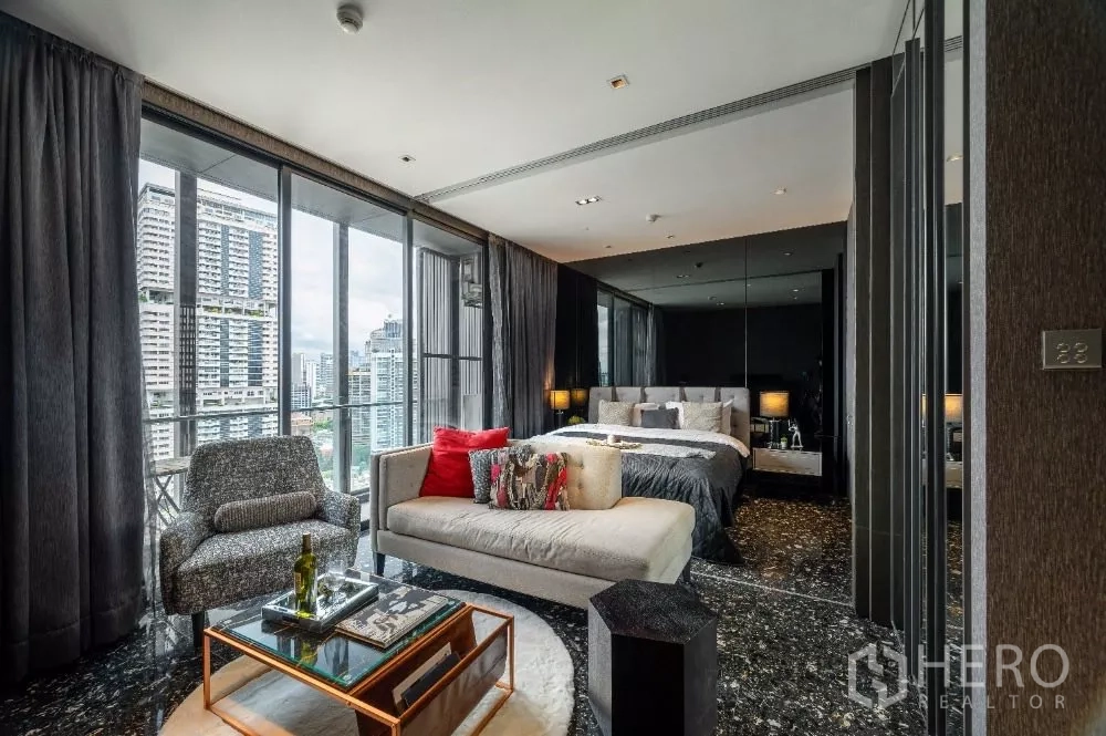 Condominium for rent or sale in Khlong Toei, Bangkok - Stylish bedroom and lounge with floor-to-ceiling windows and Bangkok skyline view.