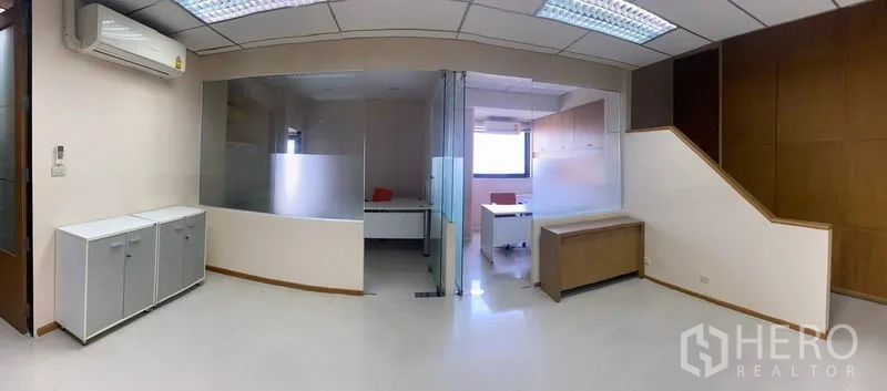 Office Space for rent in Din Daeng, Bangkok - Wide view of office showing two glass-partition rooms, air-conditioning and built-in cabinetry.