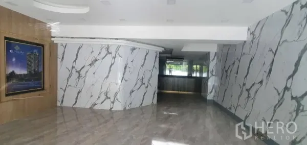 Retail Space for rent in Watthana, Bangkok - Polished retail interior with marble-clad walls, glossy floors and a counter near windows.