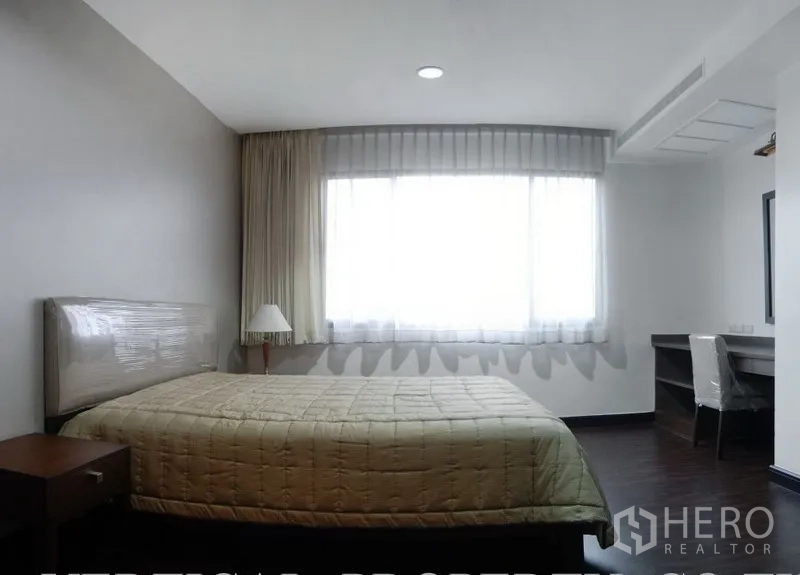 公寓 出租在Watthana, Bangkok - 卧室带大窗与书桌，浅色装饰