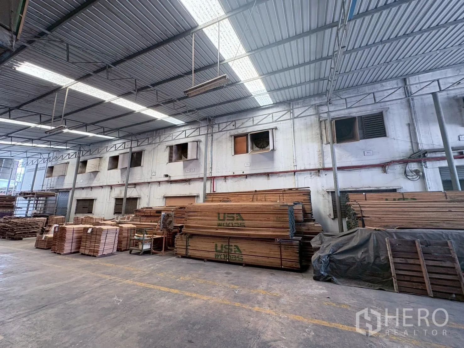 工厂 出租或出售在Bang Khun Thian, Bangkok - 有顶仓库区，金属屋面采光，堆放大量木材。