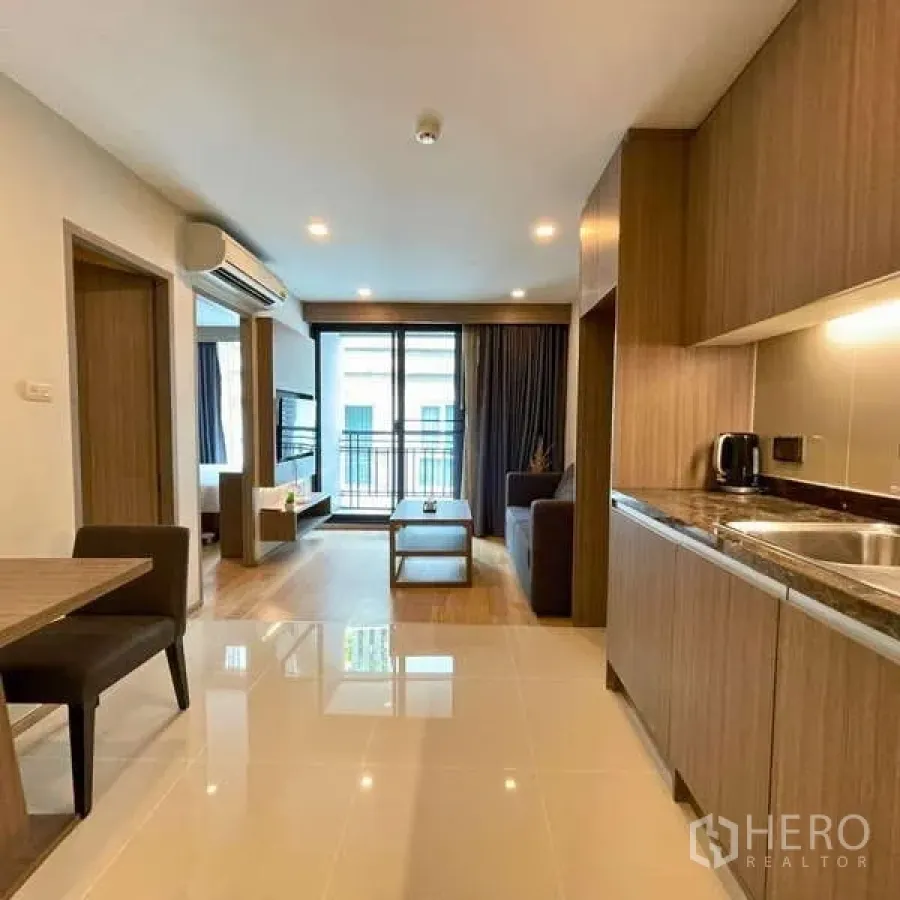 Condominium for rent - Open-plan condo view from entry toward the living area and balcony.