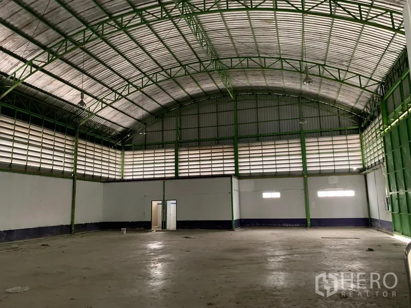 คลังสินค้า ให้เช่าในLam Luk Ka, Pathum Thani - ภายในโกดังโปร่ง เพดานโค้งโครงเหล็กสีเขียว มีช่องลมและพื้นคอนกรีต
