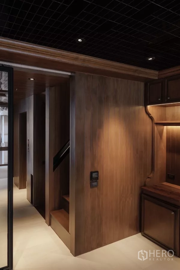 Office Space for rent in Bang Rak, Bangkok - Wood‑paneled office corridor with compact staircase and a built‑in desk nook
