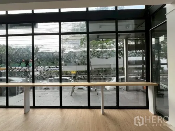 Retail Space for rent in Watthana, Bangkok - Floor-to-ceiling windows facing the street with a long display counter.