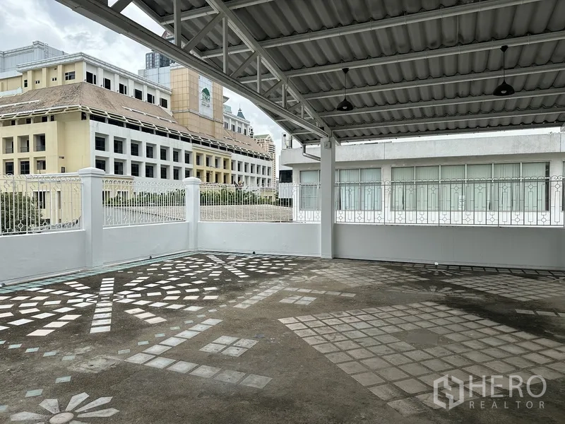 Retail Space for rent in Bang Rak, Bangkok - Covered open-air terrace with railing and views of neighboring buildings.