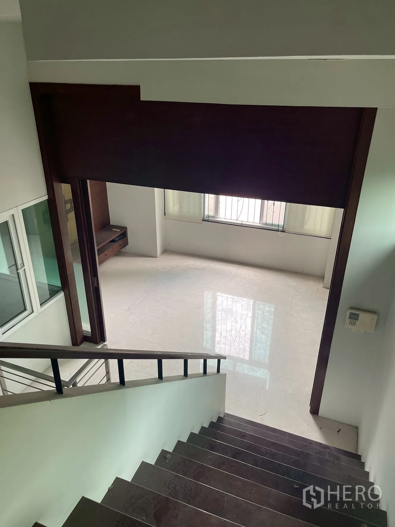 带办公室的家 出租在Wang Thonglang, Bangkok - 楼梯向下望向开放式房间，亮面地砖与窗户