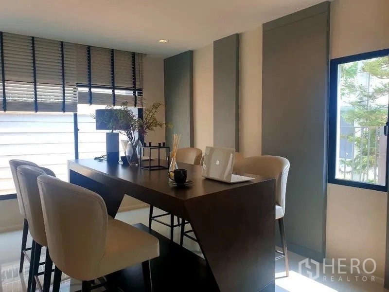 Home Office for rent in Bang Phli, Samut Prakan - High-table meeting space with upholstered stools and window blinds.